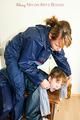 Leonie tied and gagged on a chest by Lia both wearing sexy shiny nylon rainwear (Pics)