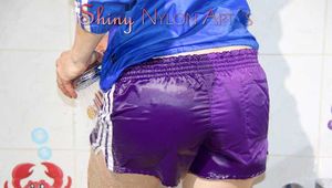 Sonja wearing a sexy purple shiny nylon shorts and a blue rain jacket while taking a shower (Pics)