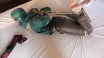 Rachel Adams tied and gagged in shiny Downwear