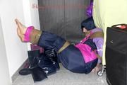 Jill tied and gagged in shiny nylon rainware