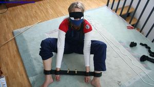 Miri tied up in a heavy steel pillory