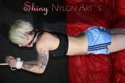 Watching ***NEW MODELL COURTNEY*** wearing a sexy lightblue shiny nylon shorts and a black top being tied and gagged overhead with ropes and a ballgag (Pics)