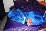 Alina tied and gagged in a shiny skisuit