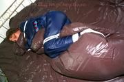 Stella tied and gagged in shiny nylon rainwear