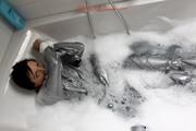 Simone in an shiny grey pvc sauna suit tied and gagged by Sophie in the bath tub (pics)