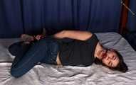 Rose hogtied on bed