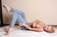 Topless barefoot Samira, cuffed with steel cuffs, poses to the camera