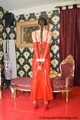Miss Scarlett bound and gagged in a long red Latex dress