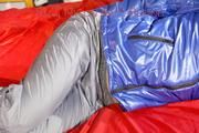 Sonja tied, gagged and hooded on bed with cuffs wearing a sexy grey shiny nylon rain pants and a blue down jacket (Pics)