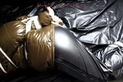 Jill tied and gagged in a shiny nylon down coat