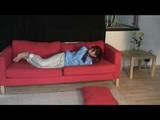 Julia tied and gagged on a sofa wearing a shiny light blue/beige PVC suit (Video)
