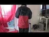 Enni dresses herself in shiny nylon shorts and rain cloths (Video)