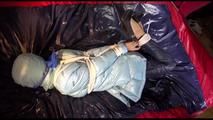 Lulu tied and gagged on a bed wearing a sexy blue shiny nylon rainpants and a iceblue PAMY downjacket (Video)