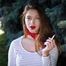 Adorable party girl Irina taking a drag on a Marlboro Red cigarette in the city park