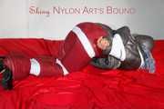 ***NEW MODEL*** Sandra wearing highheels and a sexy red crazy sensation skibib as well as a grey down jacket tied and gagged on a sofa with tape (Pics)
