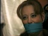 . 41 Yr OLD RED HEADED FAMOUS FASHION MODEL IS OTM GAGGED, BAREFOOT, TOE-TIED, HOPS AROUND ROOM, TIES, GAGS AND HANDCUFFS HERSELF WHILE WEARING BLUE JEANS  PT 8  (D60-5)