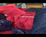 Sonja posing and lolling on bed wearing a sexy blue/red rainwear combination (Video)