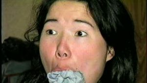 25 YEAR OLD ASIAN MAI-LING IS MOUTH STUFFED, CLEAVE GAGGED, WEARING GLASSES, HOG-TIED, WEARING PANTYHOSE WITH TOES & FEET TIED (D50-4)