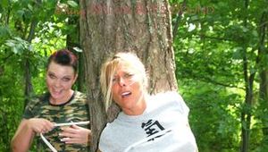 Jill ties and gagges an archive girl outdoor on a tree both wearing shiny nylon shorts and shirts (Pics)