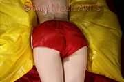 Sexy Sonja posing for you in a red shiny nylon shorts and a tshirts and then she takes it off and plays with the bedding (Pics)