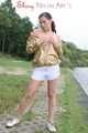Watching out beautiful archive girl wearing a white shiny nylon shorts and a golden rain jacket posing outdoor (Pics)