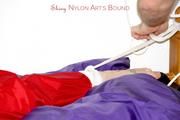 Jill tied and gagged in shiny nylon rainware