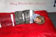 ***NEW MODEL*** Sandra wearing highheels and a sexy red crazy sensation skibib as well as a grey down jacket tied and gagged on a sofa with tape (Pics)