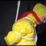 MARA tied and gagged overhead with ropes and a ballgag wearing a super sexy super shiny black rain pants, rubber boots and a yellow down jacket (Video)
