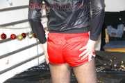 PIA wearing sexy black stockings, a red shiny nylon shorts, high heels and a black rain jacket posing infront of the mirror and on bed (Pics)