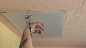 Sunny cuffed on a ladder