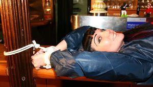 Jill tied and gagged in shiny rainwear