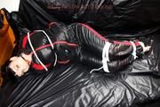 Jill bound and gagged in a shiny nylon skisuit