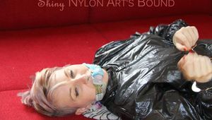 Mara ties and gagges herself on the sofa with a bar wearing a sexy orange rain pants and a black rain jacket (Pics)