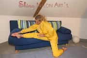 Sexy blonde archive girl posing and lolling on a sofa wearing sexy yellow rainwear over nothing (Pics)