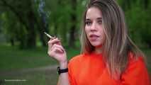 Pretty Kate is smoking Marlboro Red 100s in the park