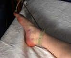 Tapegagged topless barefoot Bianca in jeans shorts, tied on the bed with her legs wide-spread, wiggles helplessly