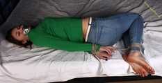 Roxana hogtied on bed