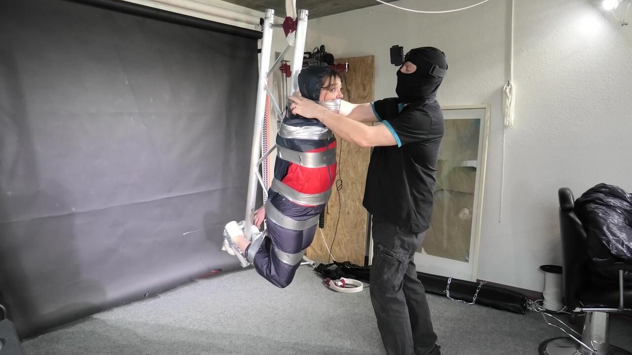 Marie Taped And Suspended In Shiny Nylon Rainwear