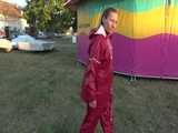 Watch Sandra taking a Walk during very hot Weather enjoying her rubberized oldschool Rainsuit