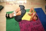 Stella tied and gagged on the floor wearing a shiny nylon rain pants (Pics)