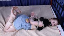 Josefa hogtied on bed