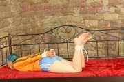 Mara tied and gagged on a princess bed in an old cellar wearing an supersexy shiny lightblue nylon shorts and an orange rain jacket (Pics)