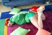Jill tied and gagged on the floor wearing a hot green shiny nylon shorts and a rain jacket (Pics)