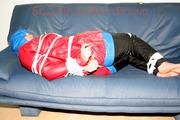 Jill tied, gagged and hooded on the sofa wearing a sexy black shiny nylon pants and two rain jackets (Pics)