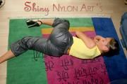 Stella posing in a living room wearing supersexy rainwear (Pics)