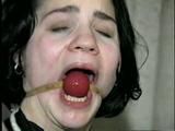 24 YR OLD GERMAN GIRL GRETCHEN IS TIED BACKWARDS ON CHAIR, HANDS TIED BEHIND HER HEAD, CROTCH ROPED, HOME MADE RUBBER BAND BALL-GAGGED & DROOLING (D51-13)