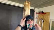 Lana tied and gagged and gagged to Post in shiny nylon Rainwear