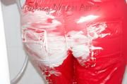 Lucy wearing a sexy red shiny nylon jumpsuit during her shower (Pics)