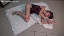 Barefoot Ekaterina in lingerie, handcuffed and legcuffed, poses on the floor