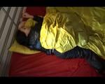 Lucy lolling in bed wearing a sexy black rainwear combination (Video)
